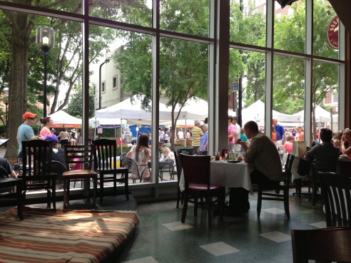 The Saturday Market going on in the background on Main Street Greenville.